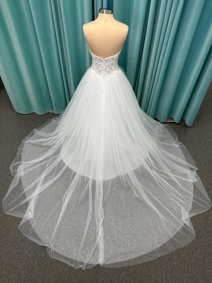 Paige ivory strapless sweetheart A-line wedding dress on mannequin with lace and tulle skirt.
