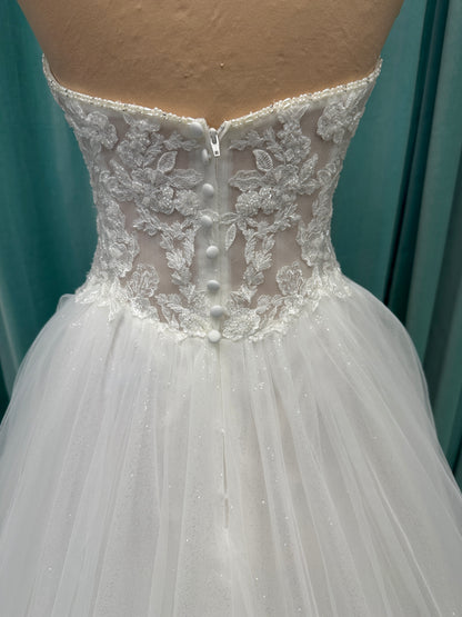 Paige ivory strapless sweetheart A-line wedding dress on mannequin with lace and tulle skirt.
