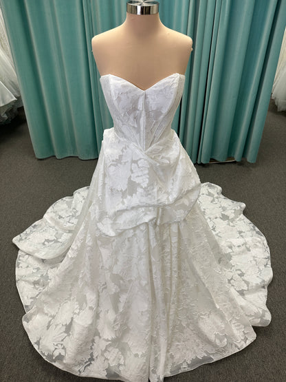 Palmer ivory strapless sweetheart A-line wedding dress on mannequin in jacquard fabric with a front thigh-high slit.
