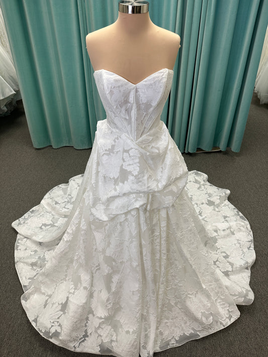 Palmer ivory strapless sweetheart A-line wedding dress on mannequin in jacquard fabric with a front thigh-high slit.
