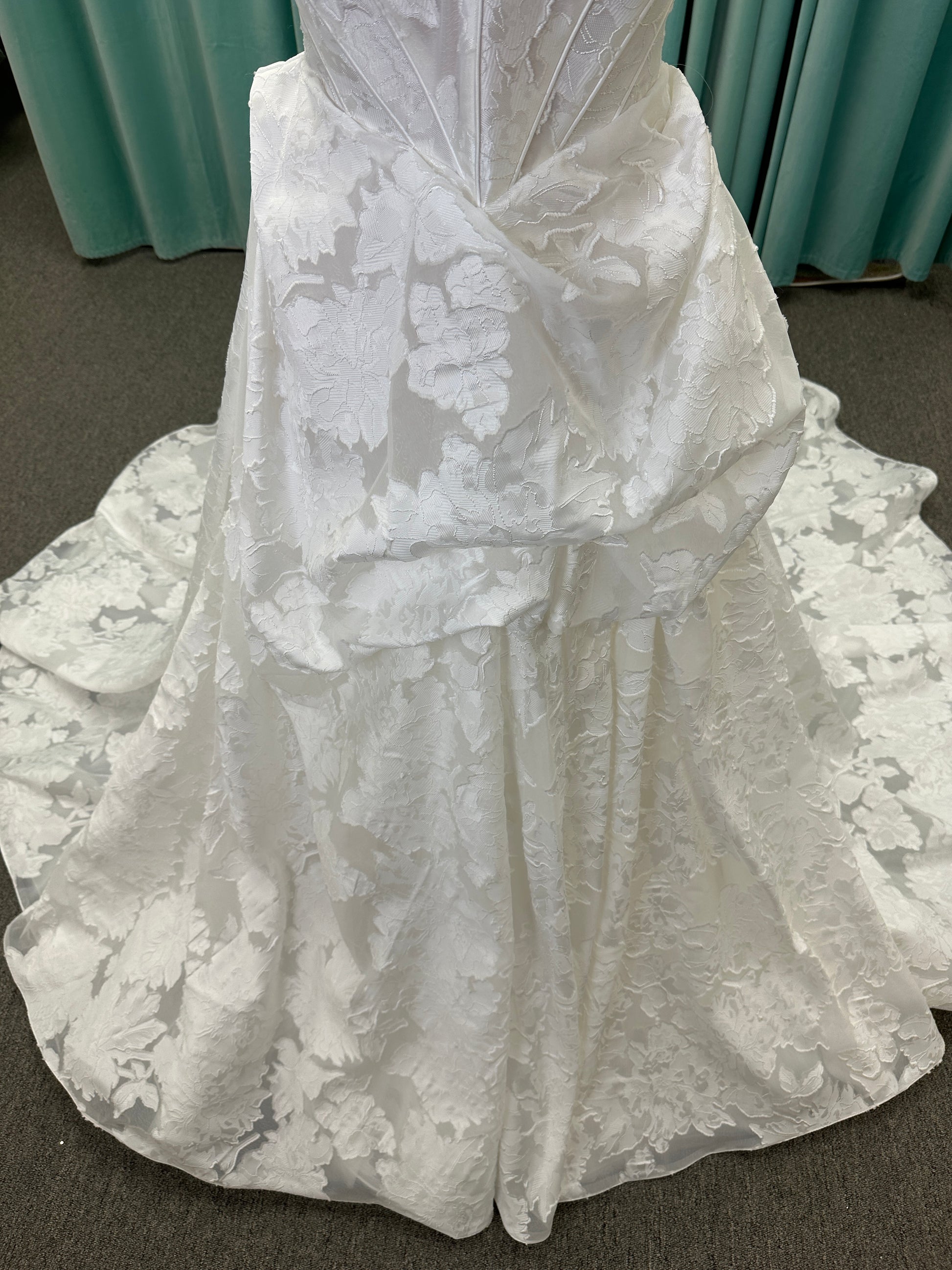 Palmer ivory strapless sweetheart A-line wedding dress on mannequin in jacquard fabric with a front thigh-high slit.
