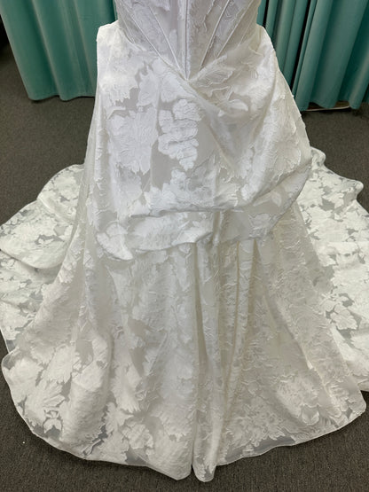 Palmer ivory strapless sweetheart A-line wedding dress on mannequin in jacquard fabric with a front thigh-high slit.
