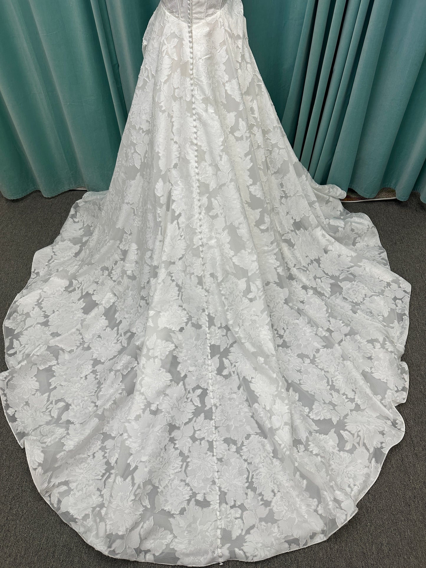Palmer ivory strapless sweetheart A-line wedding dress on mannequin in jacquard fabric with a front thigh-high slit.
