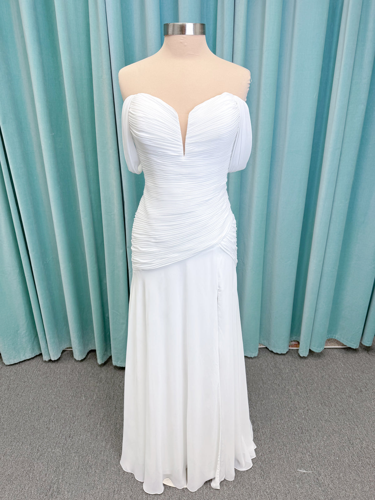 Morilee 15053 Parvati ballgown wedding dress on mannequin with draped chiffon bodice, plunging sweetheart neckline, and detachable off-the-shoulder sleeves