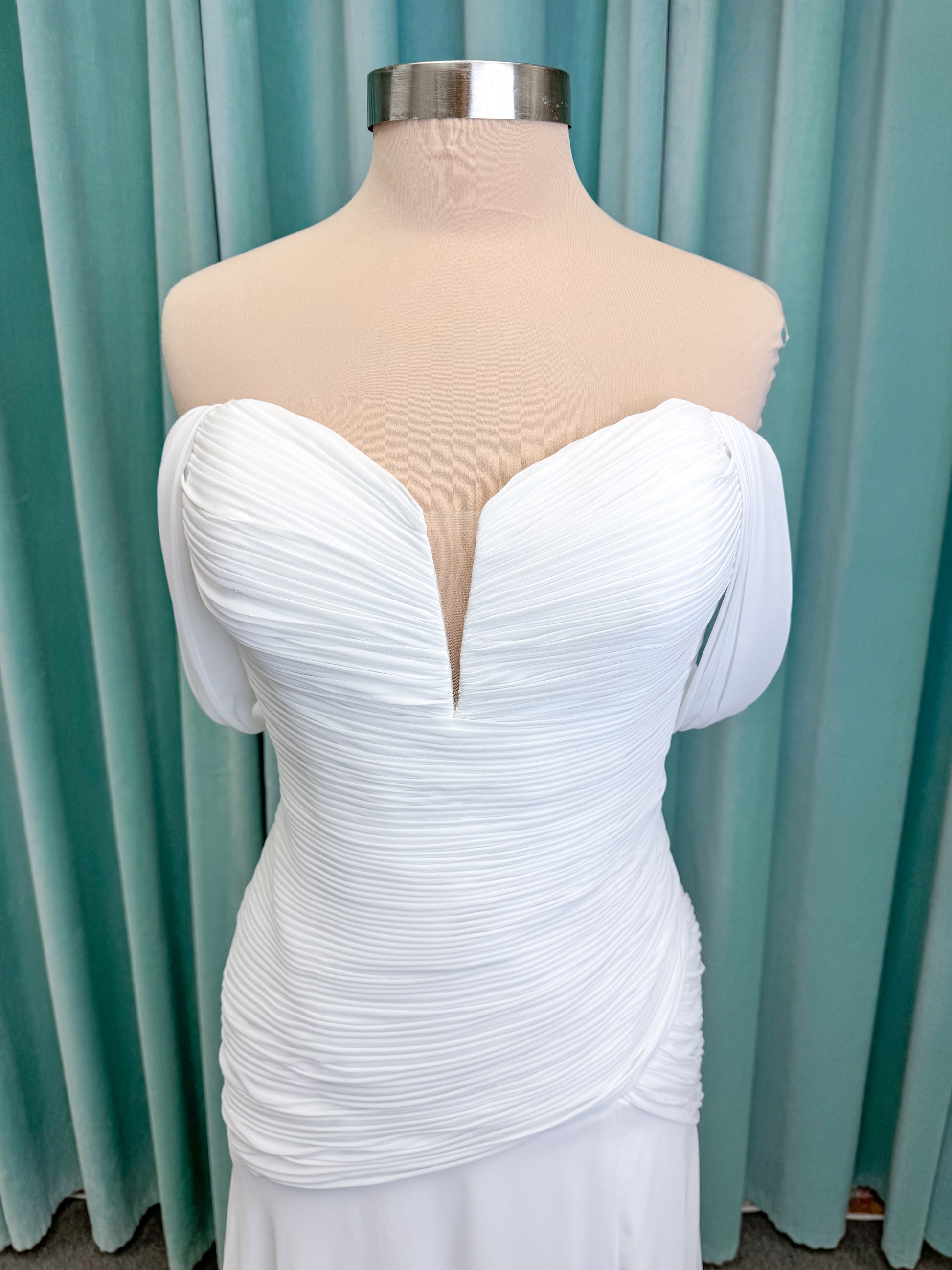 Morilee 15053 Parvati ballgown wedding dress on mannequin with draped chiffon bodice, plunging sweetheart neckline, and detachable off-the-shoulder sleeves
