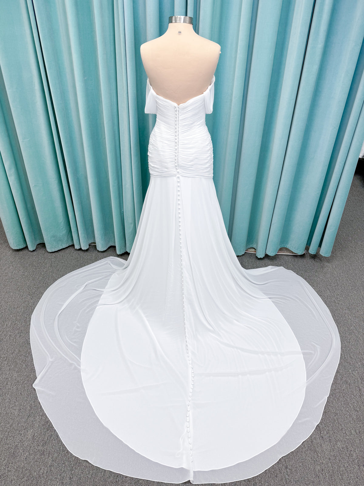 Morilee 15053 Parvati ballgown wedding dress on mannequin with draped chiffon bodice, plunging sweetheart neckline, and detachable off-the-shoulder sleeves