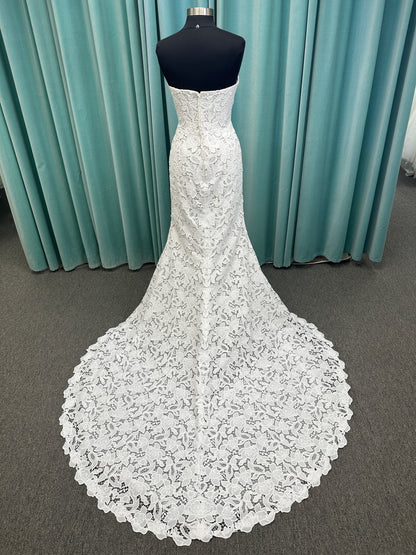 Patty ivory strapless sheath wedding dress on mannequin with sweetheart neckline and lace detail.
