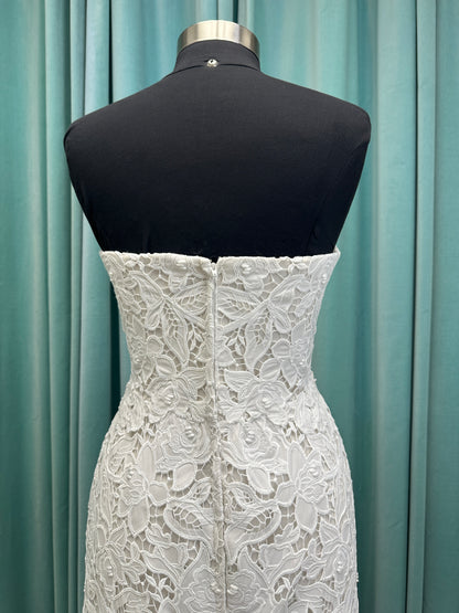 Patty ivory strapless sheath wedding dress on mannequin with sweetheart neckline and lace detail.
