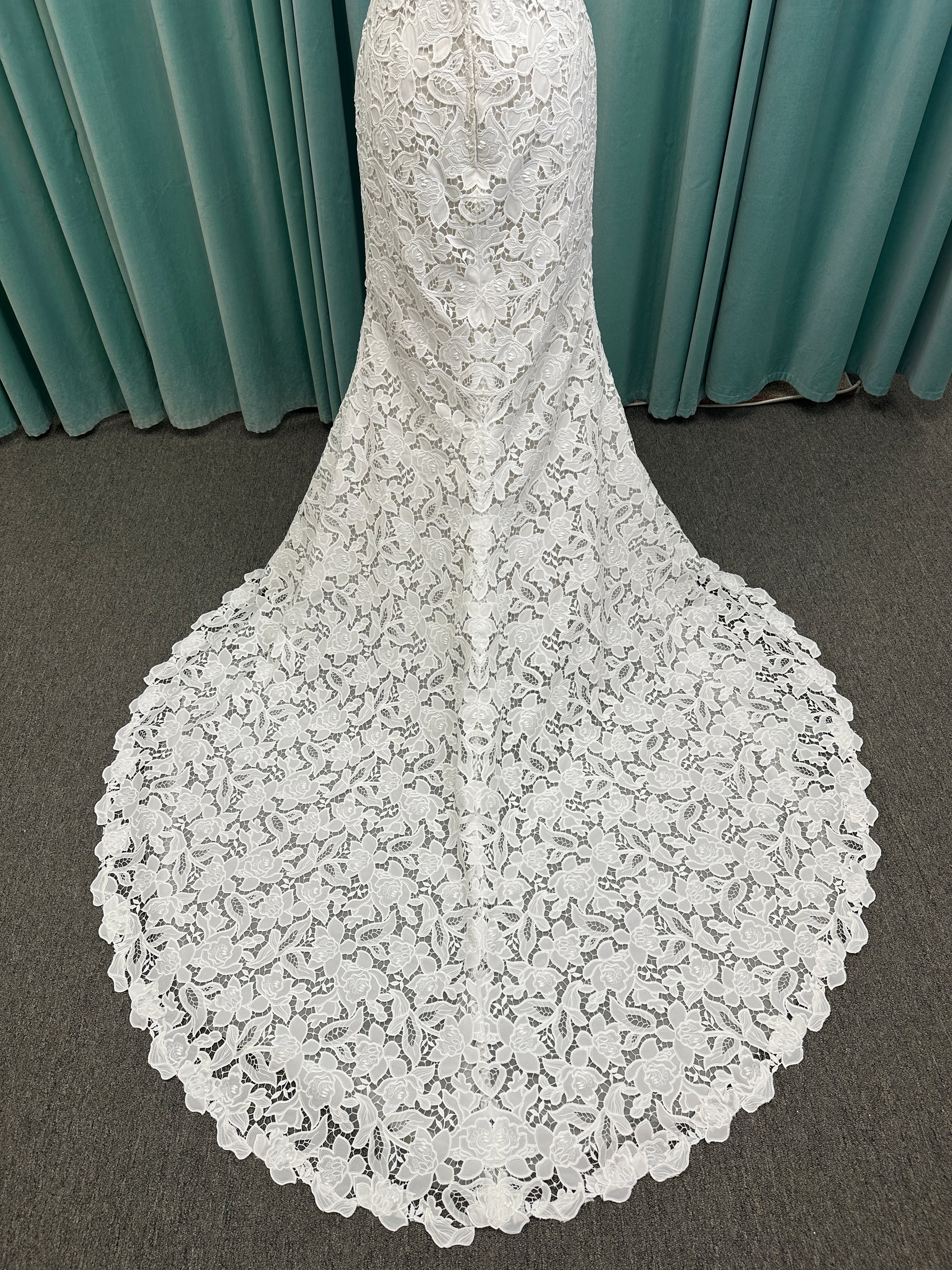 Patty ivory strapless sheath wedding dress on mannequin with sweetheart neckline and lace detail.
