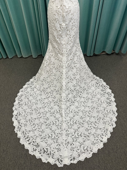 Patty ivory strapless sheath wedding dress on mannequin with sweetheart neckline and lace detail.
