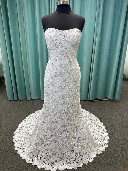 Patty ivory strapless sheath wedding dress on mannequin with sweetheart neckline and lace detail.
