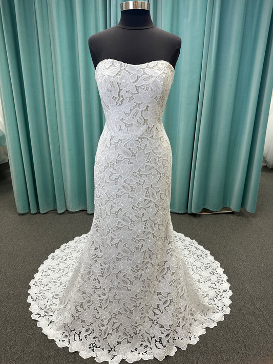 Patty ivory strapless sheath wedding dress on mannequin with sweetheart neckline and lace detail.
