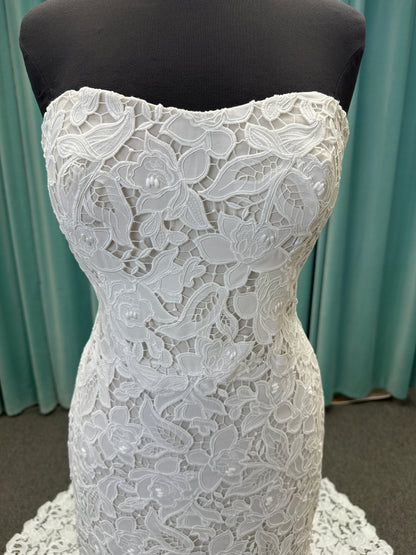 Patty ivory strapless sheath wedding dress on mannequin with sweetheart neckline and lace detail.
