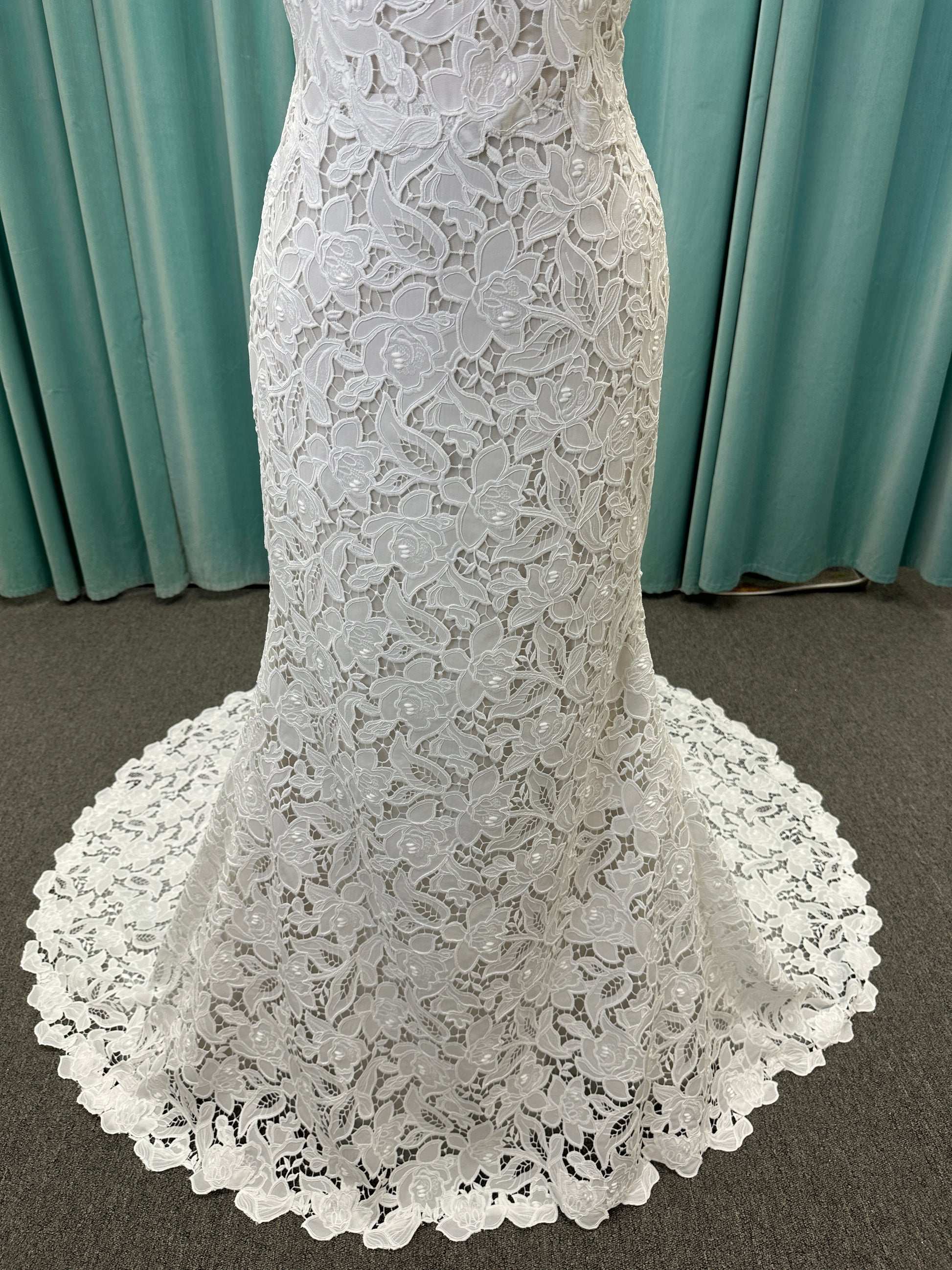 Patty ivory strapless sheath wedding dress on mannequin with sweetheart neckline and lace detail.

