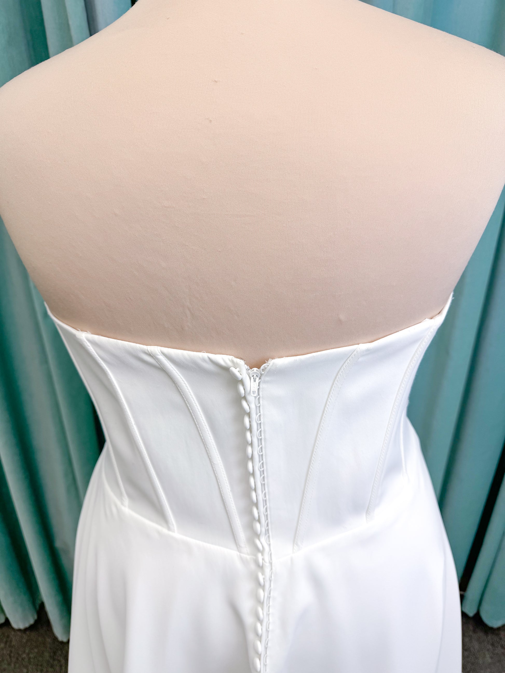 Morilee 15054 Pippa plus size A-line wedding dress in petal satin with cowl neck, corset bodice, pockets, front slit, and covered buttons to hem.