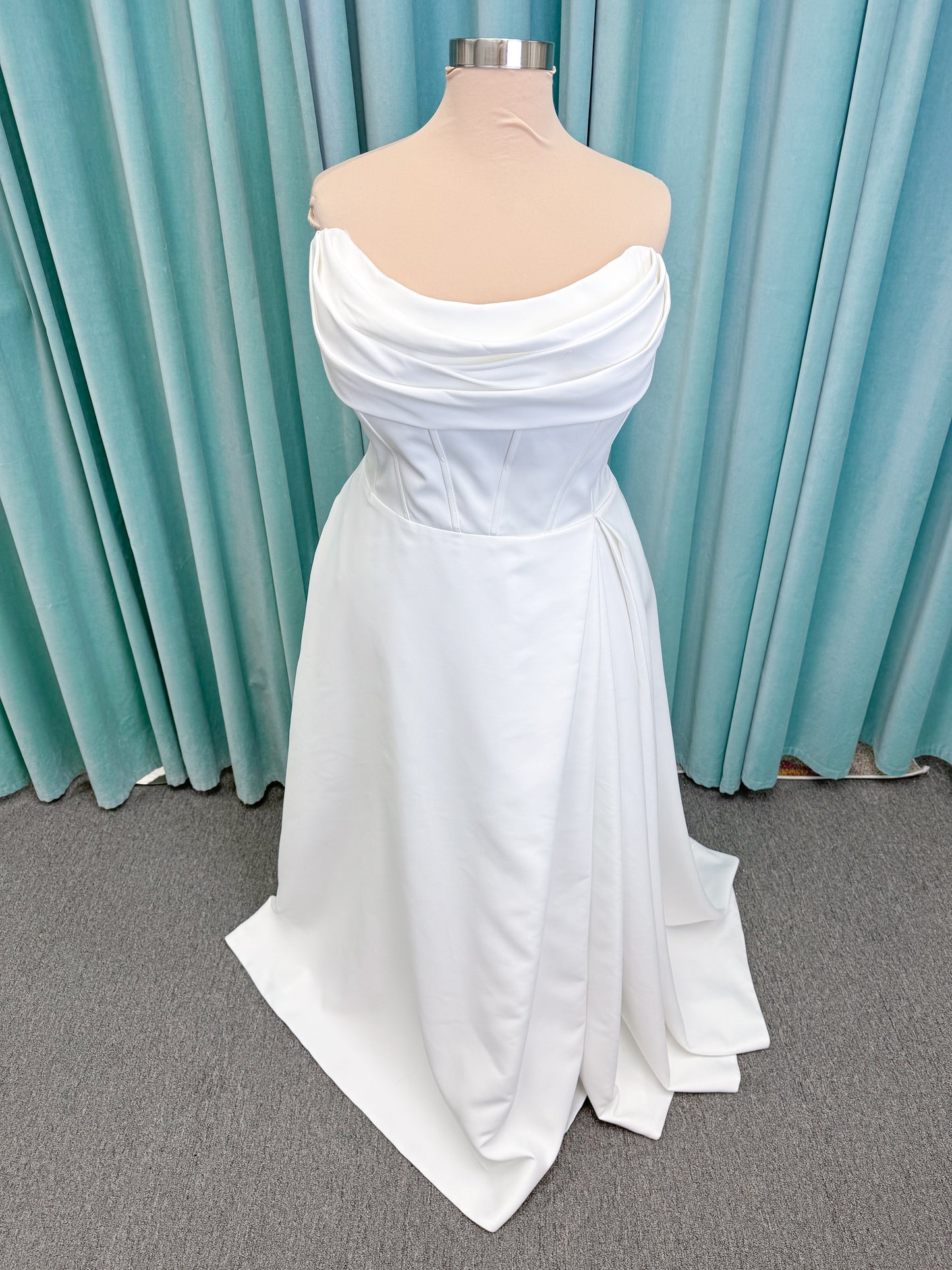 Morilee 15054 Pippa plus size A-line wedding dress in petal satin with cowl neck, corset bodice, pockets, front slit, and covered buttons to hem.