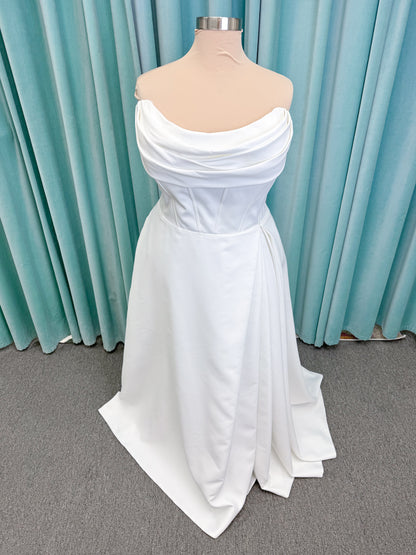 Morilee 15054 Pippa plus size A-line wedding dress in petal satin with cowl neck, corset bodice, pockets, front slit, and covered buttons to hem.