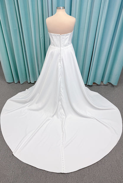 Morilee 15054 Pippa plus size A-line wedding dress in petal satin with cowl neck, corset bodice, pockets, front slit, and covered buttons to hem.