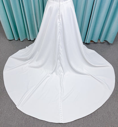 Morilee 15054 Pippa plus size A-line wedding dress in petal satin with cowl neck, corset bodice, pockets, front slit, and covered buttons to hem.