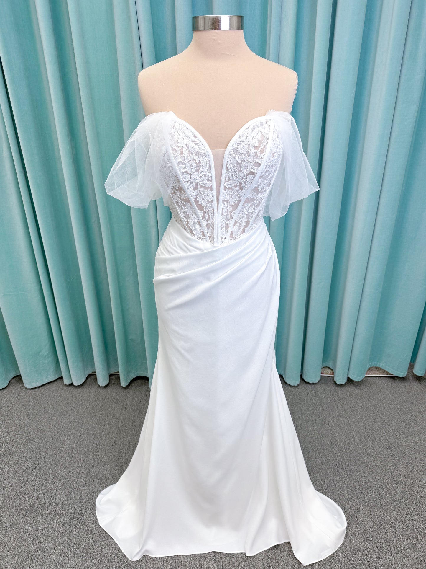 Morilee 1050008 Plie fit and flare wedding dress on mannequin with fluid draping and clean silhouette