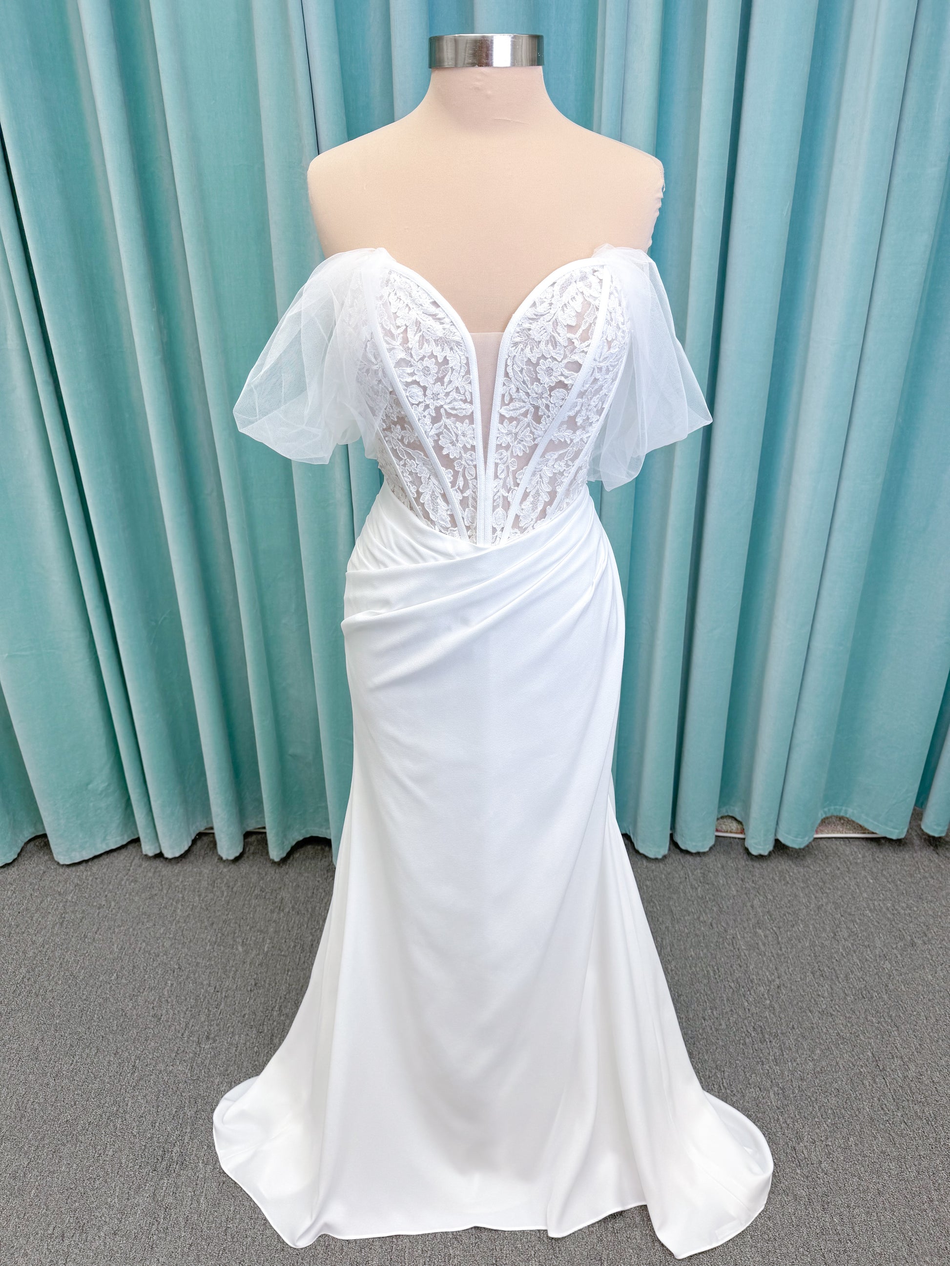 Morilee 1050008 Plie fit and flare wedding dress on mannequin with fluid draping and clean silhouette