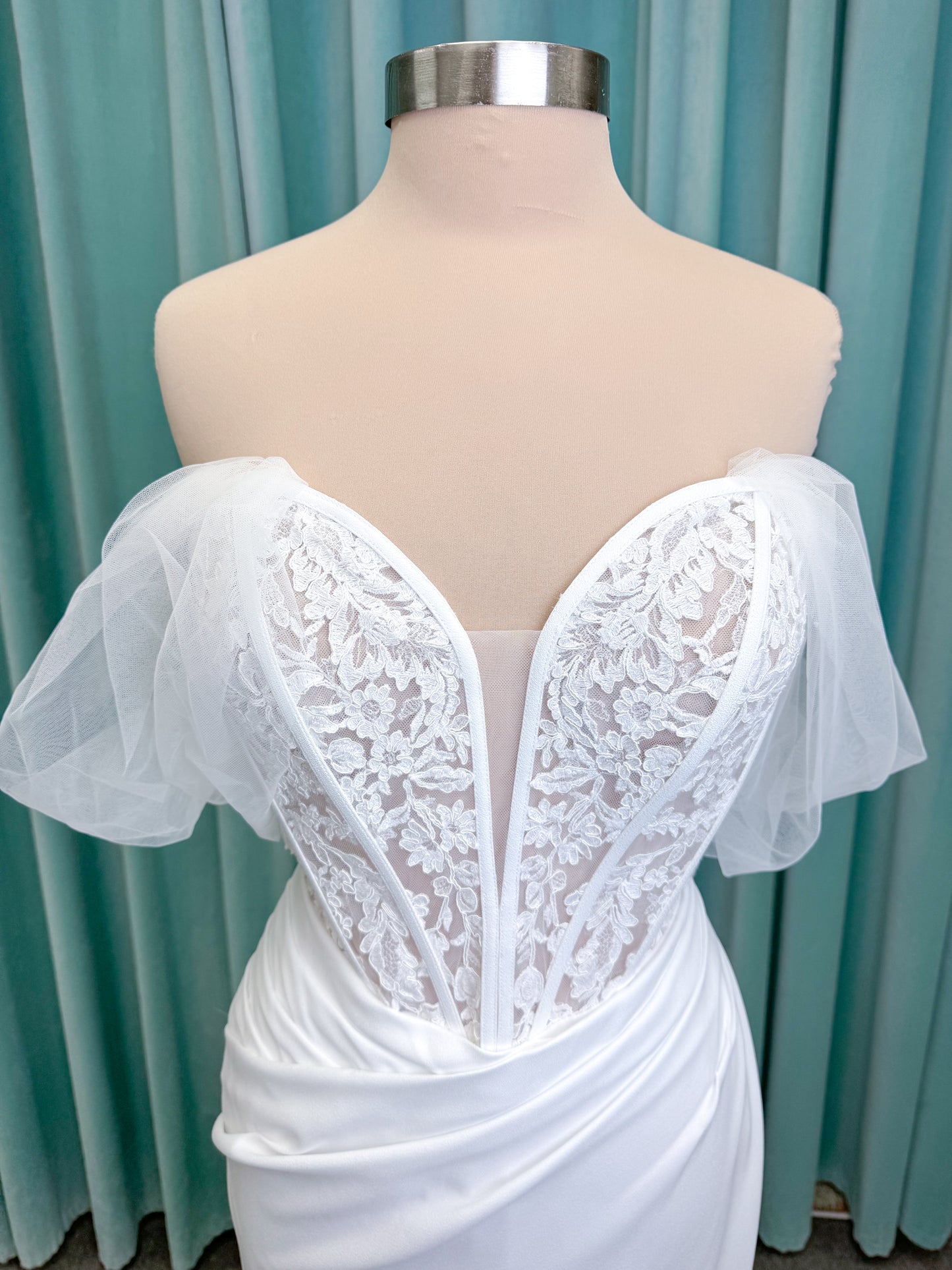 Morilee 1050008 Plie fit and flare wedding dress on mannequin with fluid draping and clean silhouette