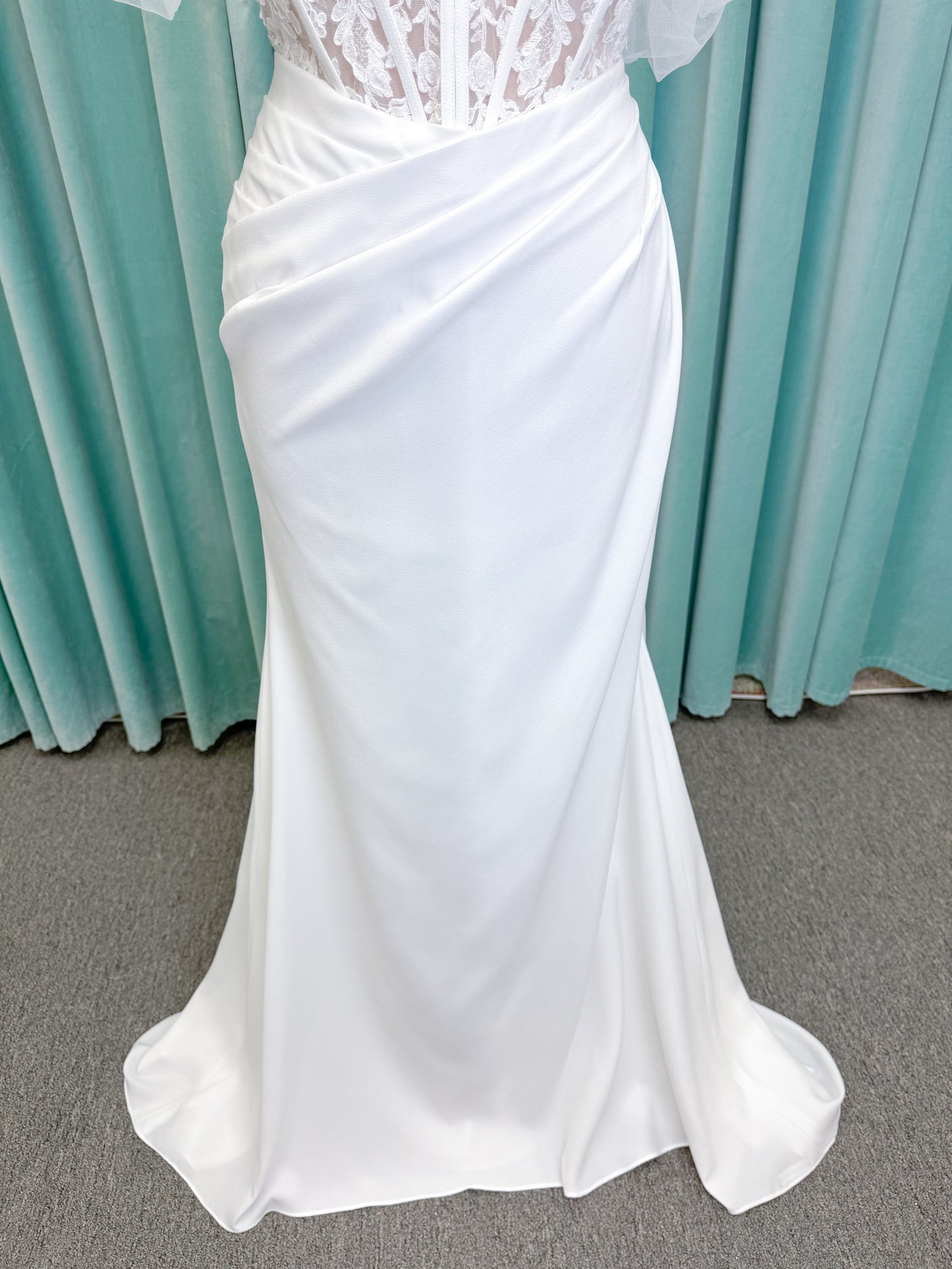 Morilee 1050008 Plie fit and flare wedding dress on mannequin with fluid draping and clean silhouette