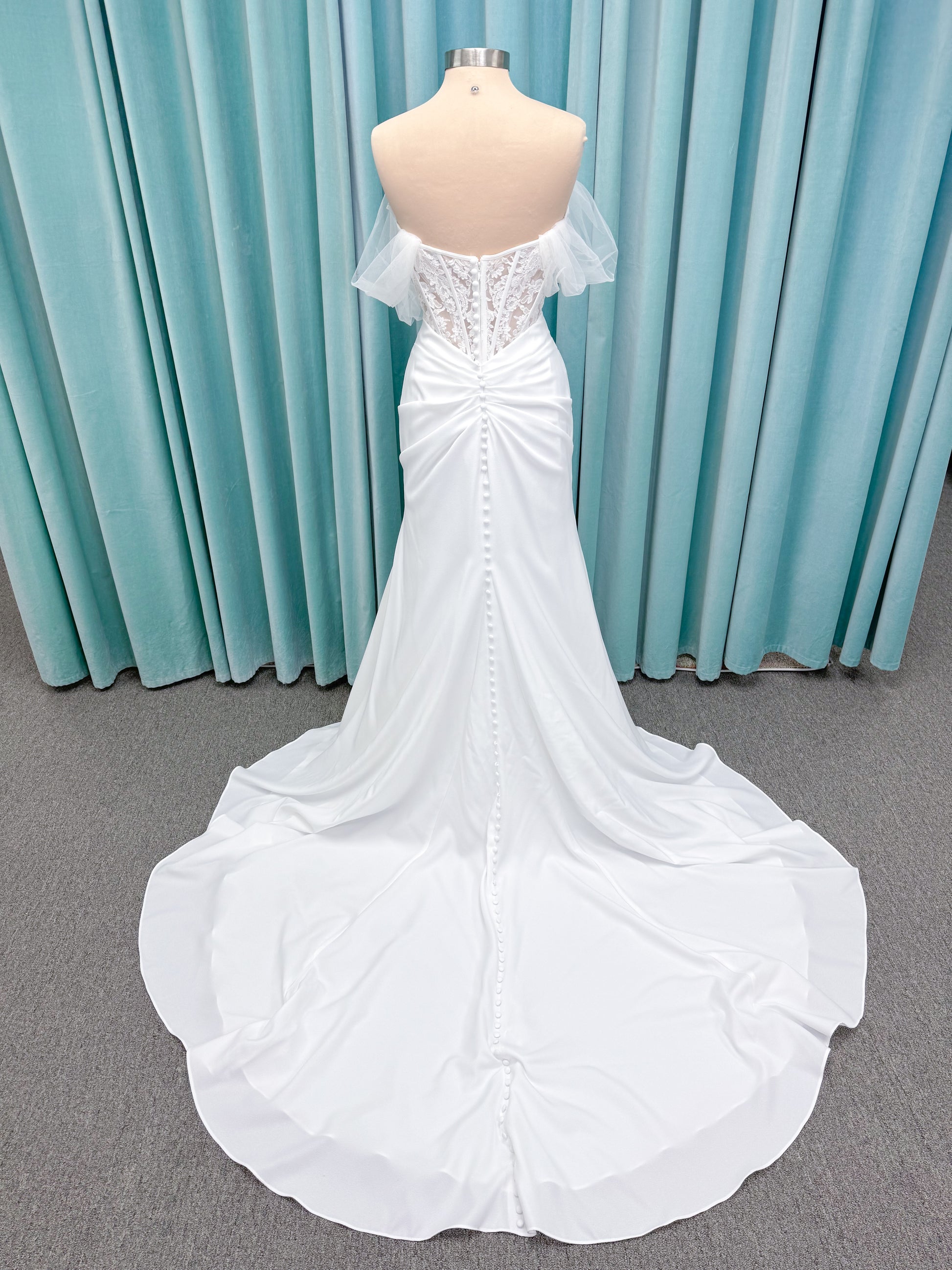 Morilee 1050008 Plie fit and flare wedding dress on mannequin with fluid draping and clean silhouette