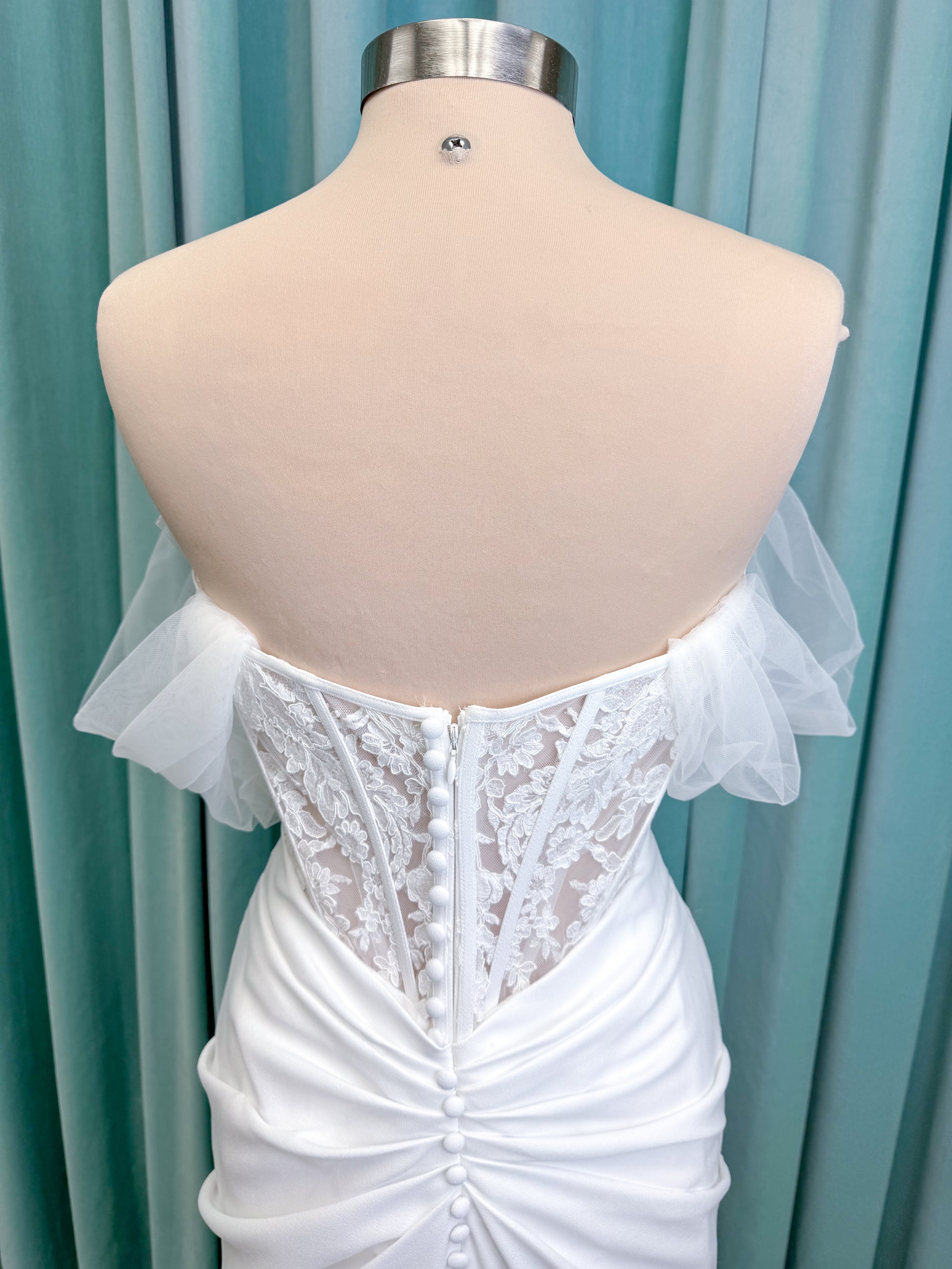 Morilee 1050008 Plie fit and flare wedding dress on mannequin with fluid draping and clean silhouette