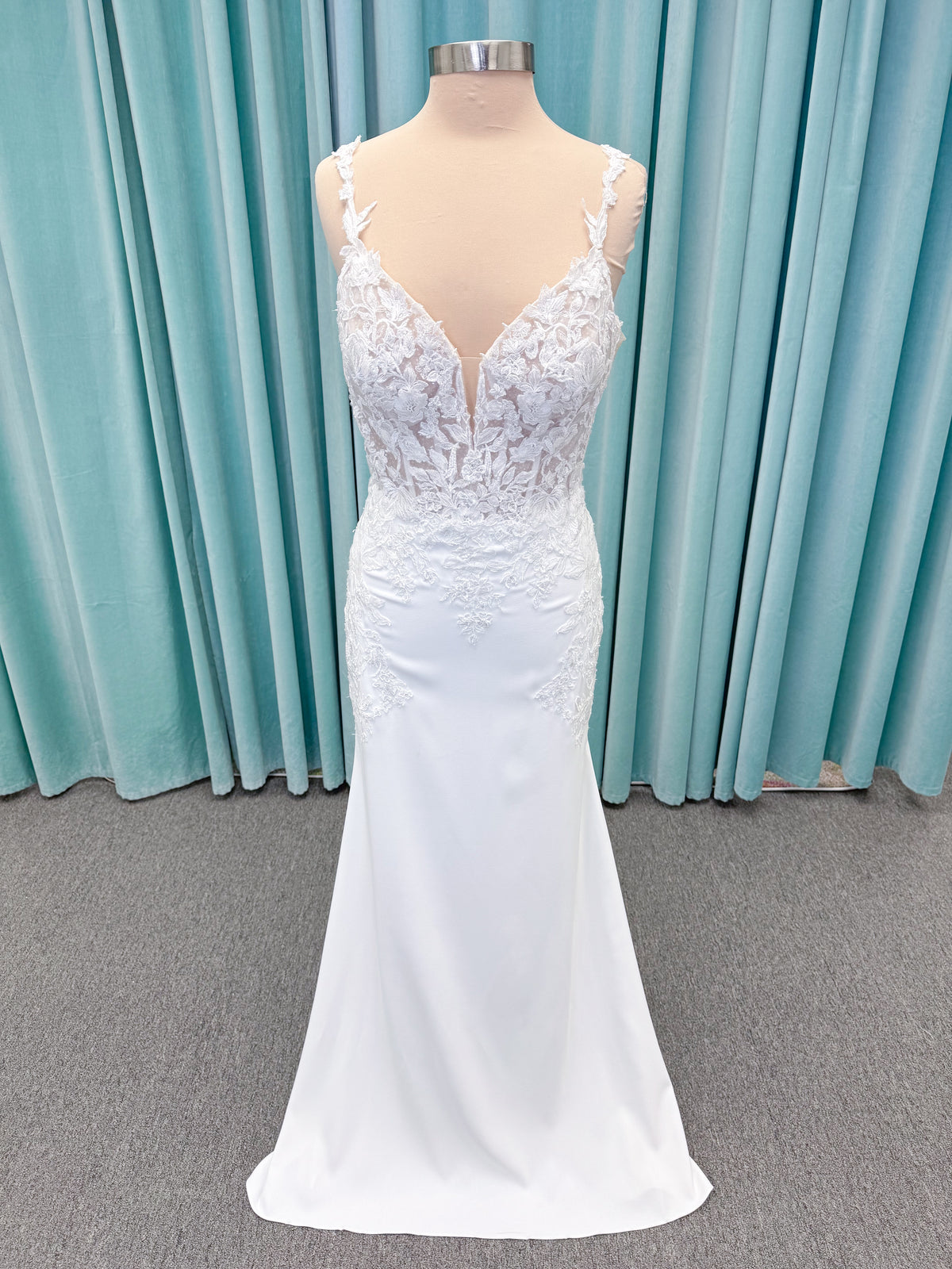 Morilee 2658 Raquel sheath wedding dress on mannequin with plunging neckline, frosted floral sparkle net bodice, crepe skirt, and keyhole back