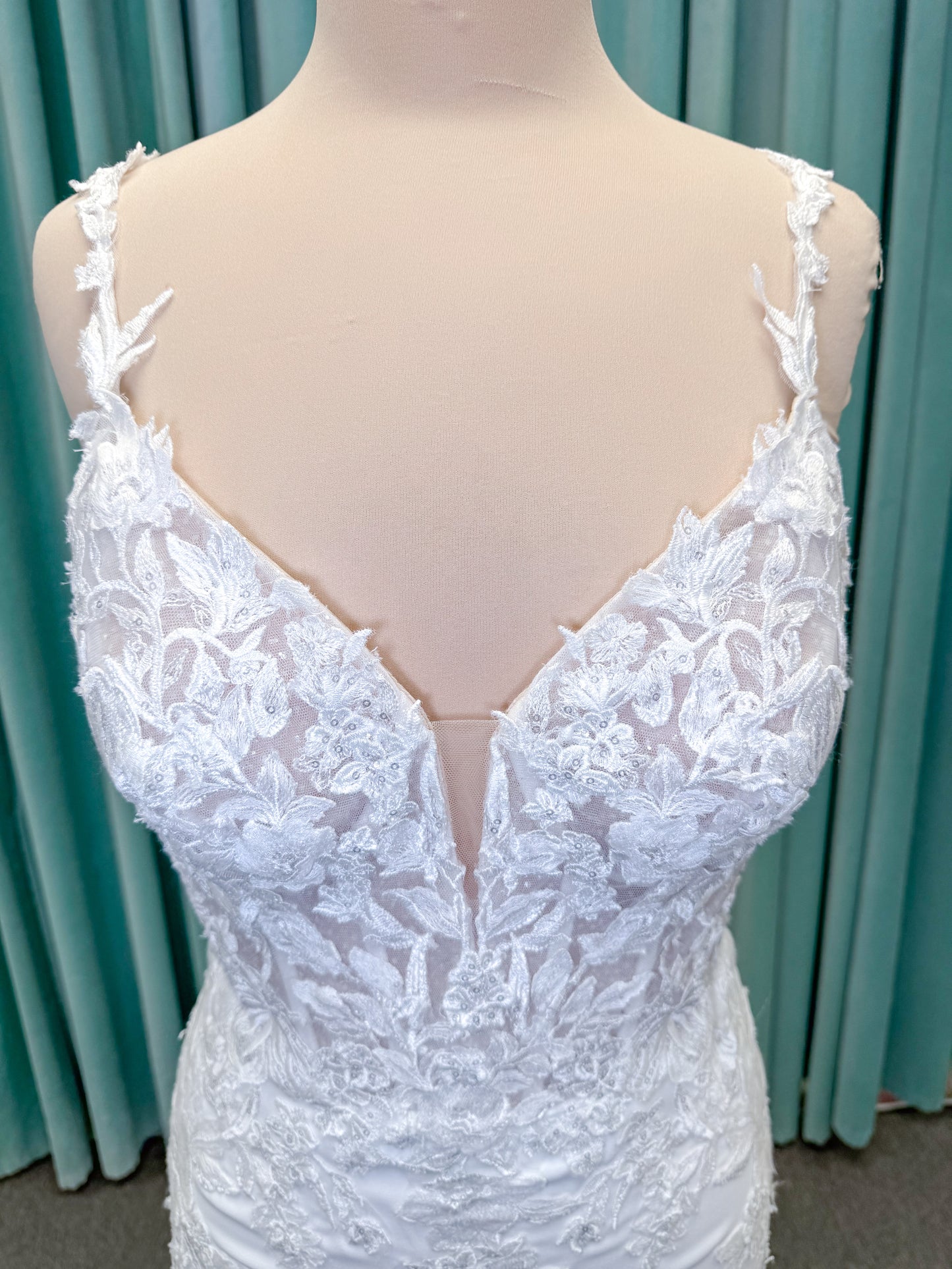 Morilee 2658 Raquel sheath wedding dress on mannequin with plunging neckline, frosted floral sparkle net bodice, crepe skirt, and keyhole back