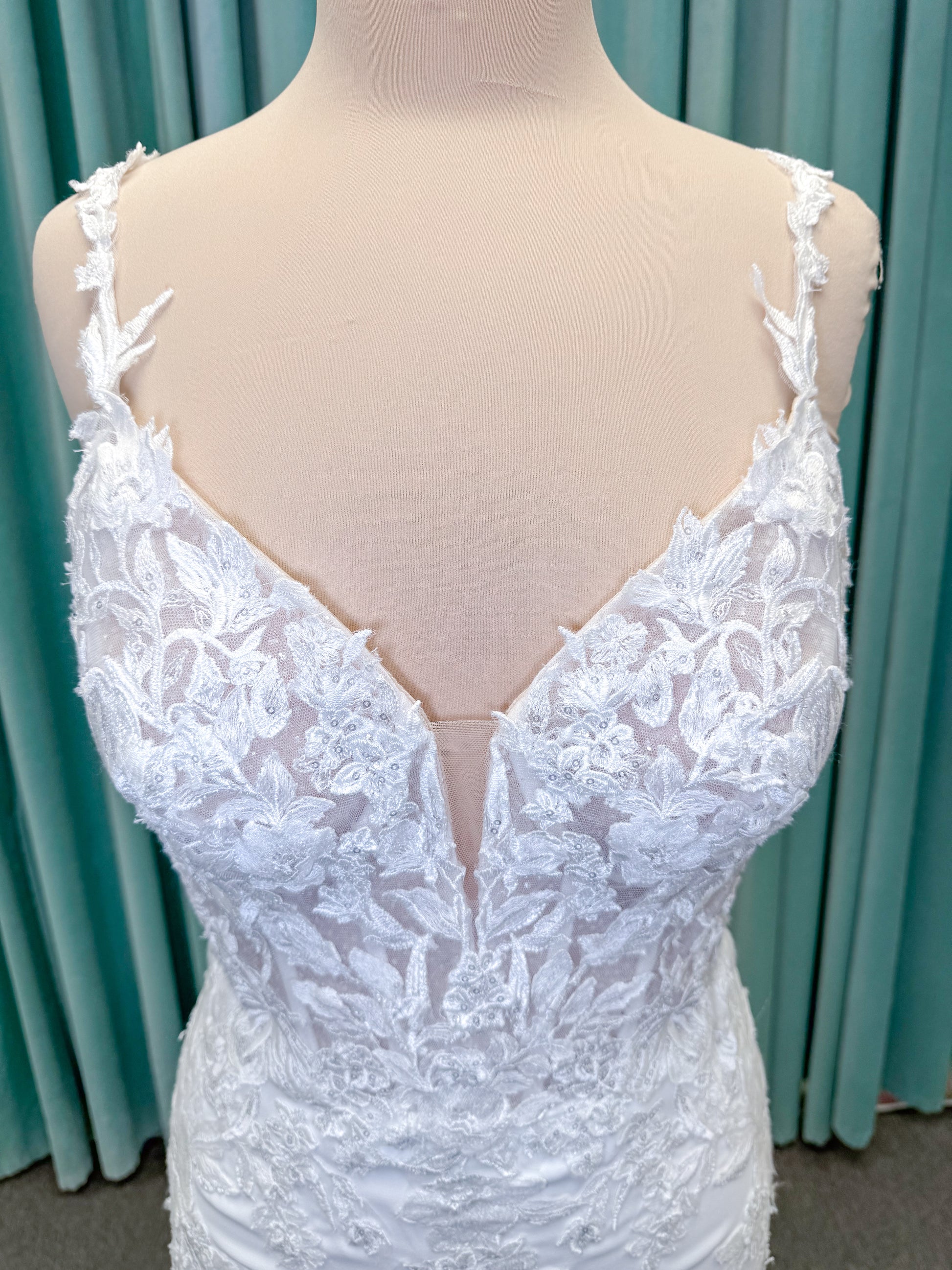 Morilee 2658 Raquel sheath wedding dress on mannequin with plunging neckline, frosted floral sparkle net bodice, crepe skirt, and keyhole back
