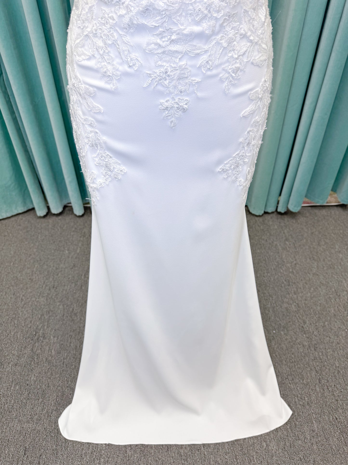 Morilee 2658 Raquel sheath wedding dress on mannequin with plunging neckline, frosted floral sparkle net bodice, crepe skirt, and keyhole back