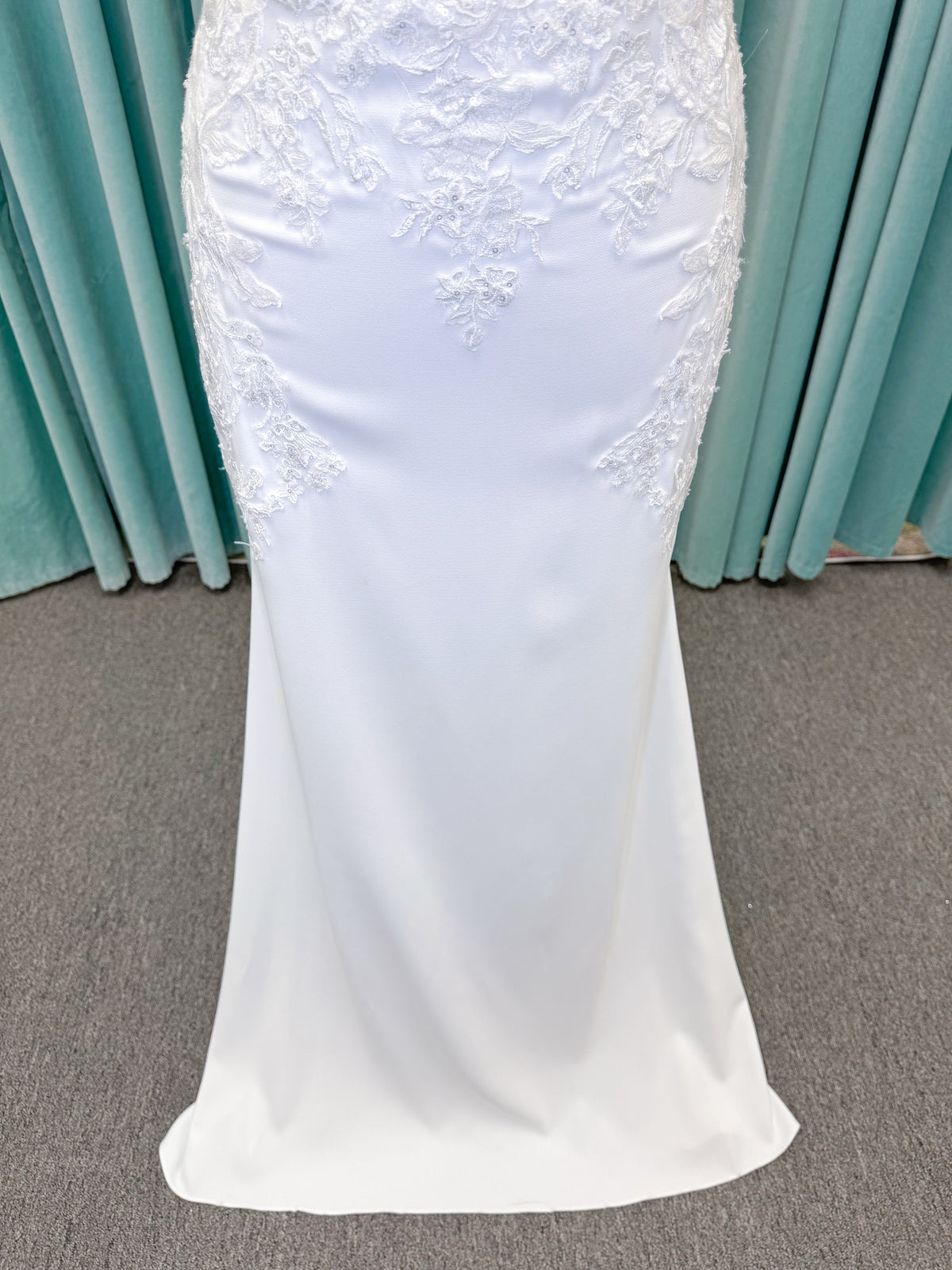 Morilee 2658 Raquel sheath wedding dress on mannequin with plunging neckline, frosted floral sparkle net bodice, crepe skirt, and keyhole back