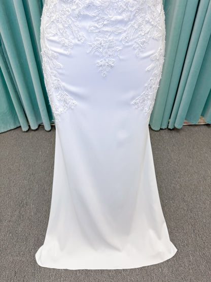 Morilee 2658 Raquel sheath wedding dress on mannequin with plunging neckline, frosted floral sparkle net bodice, crepe skirt, and keyhole back