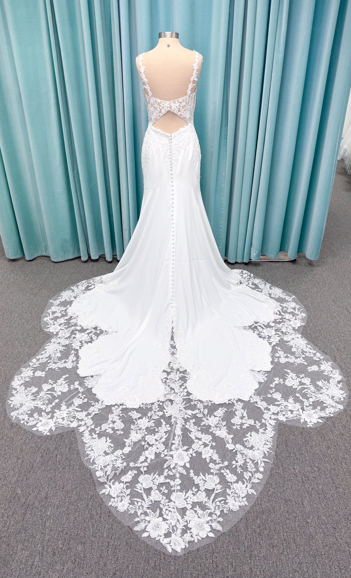 Morilee 2658 Raquel sheath wedding dress on mannequin with plunging neckline, frosted floral sparkle net bodice, crepe skirt, and keyhole back
