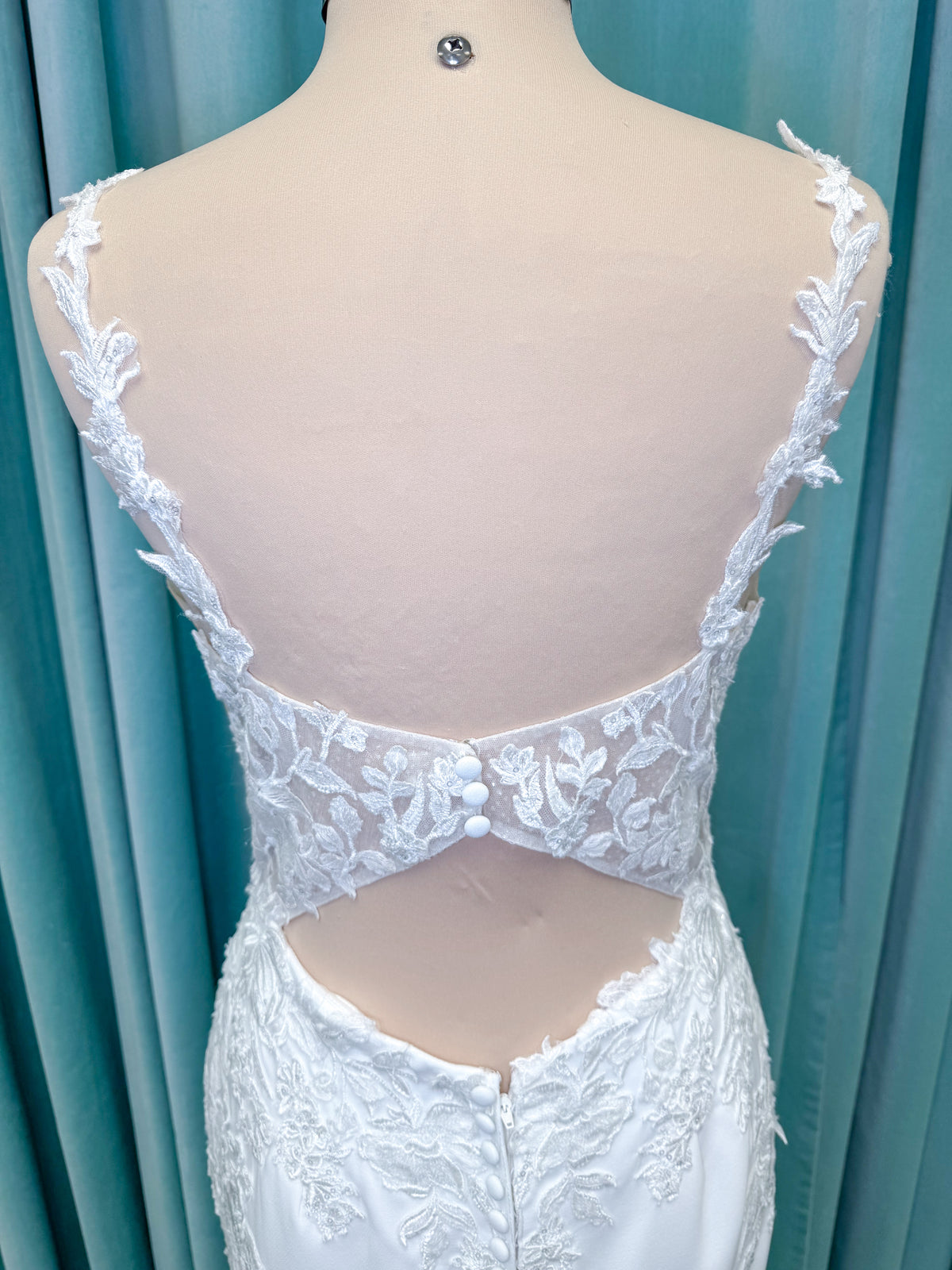 Morilee 2658 Raquel sheath wedding dress on mannequin with plunging neckline, frosted floral sparkle net bodice, crepe skirt, and keyhole back