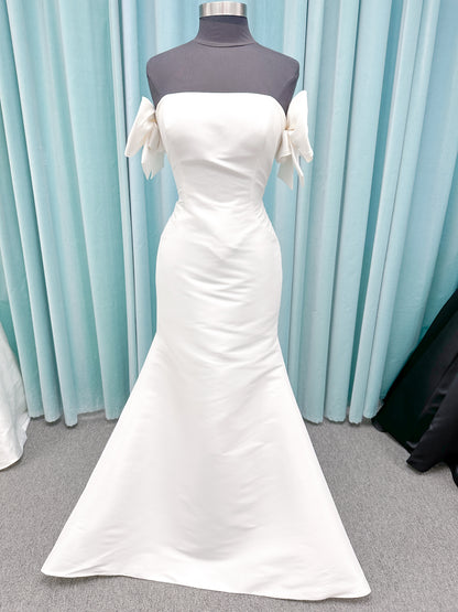 Morilee 4475 Raven fit and flare wedding dress in Larissa satin with strapless neckline, princess seams, keyhole bow back, and detachable bow sleeves.