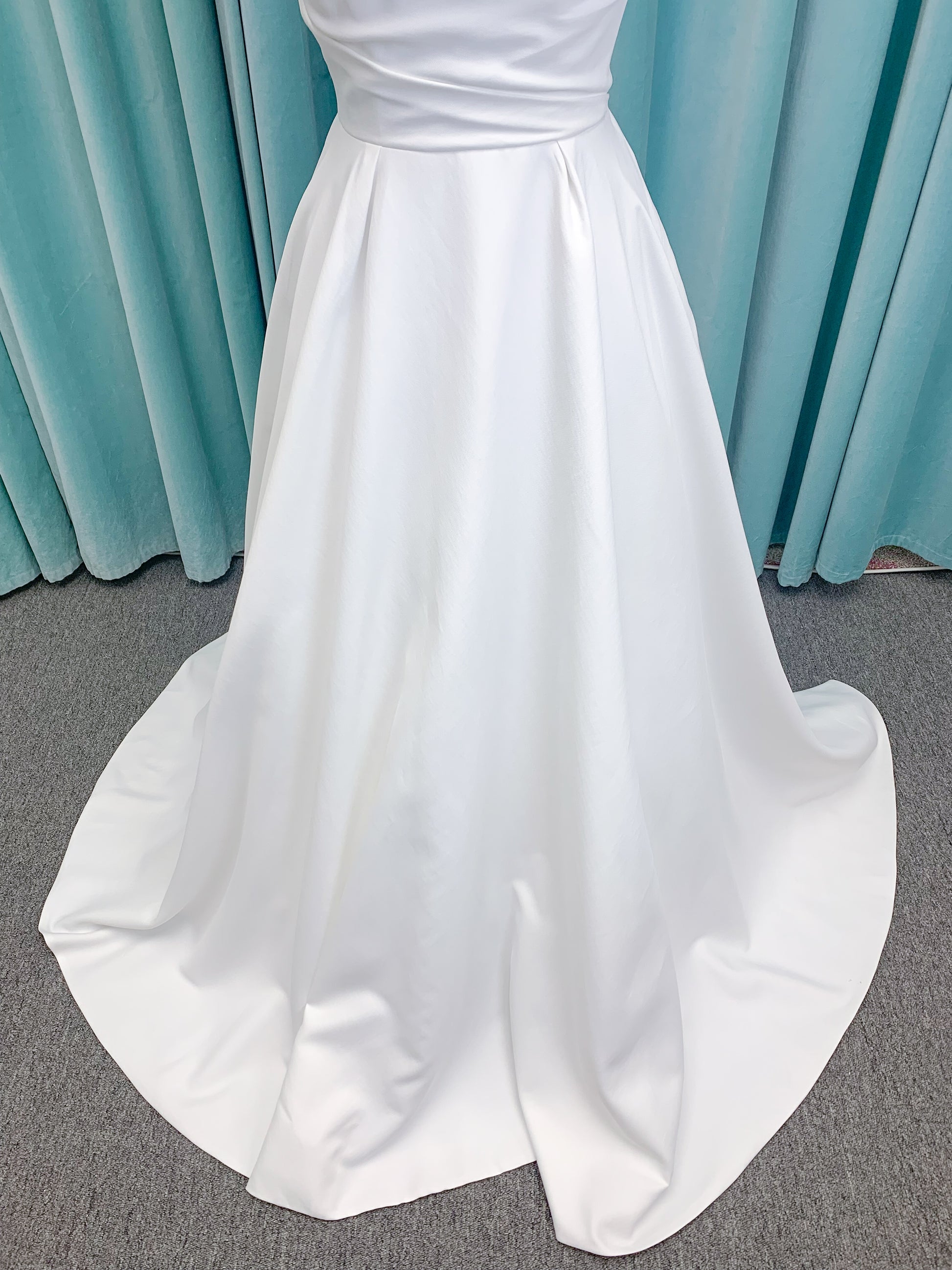 Morilee 4473 Reba A-line wedding dress in Larissa satin with cowl strapless neckline, detachable organza bow tie straps, and covered buttons to hem.