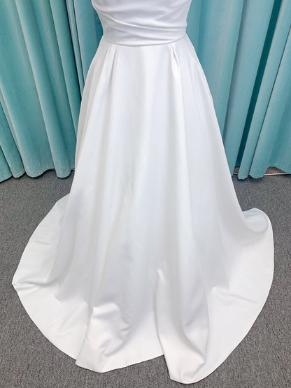 Morilee 4473 Reba A-line wedding dress in Larissa satin with cowl strapless neckline, detachable organza bow tie straps, and covered buttons to hem.