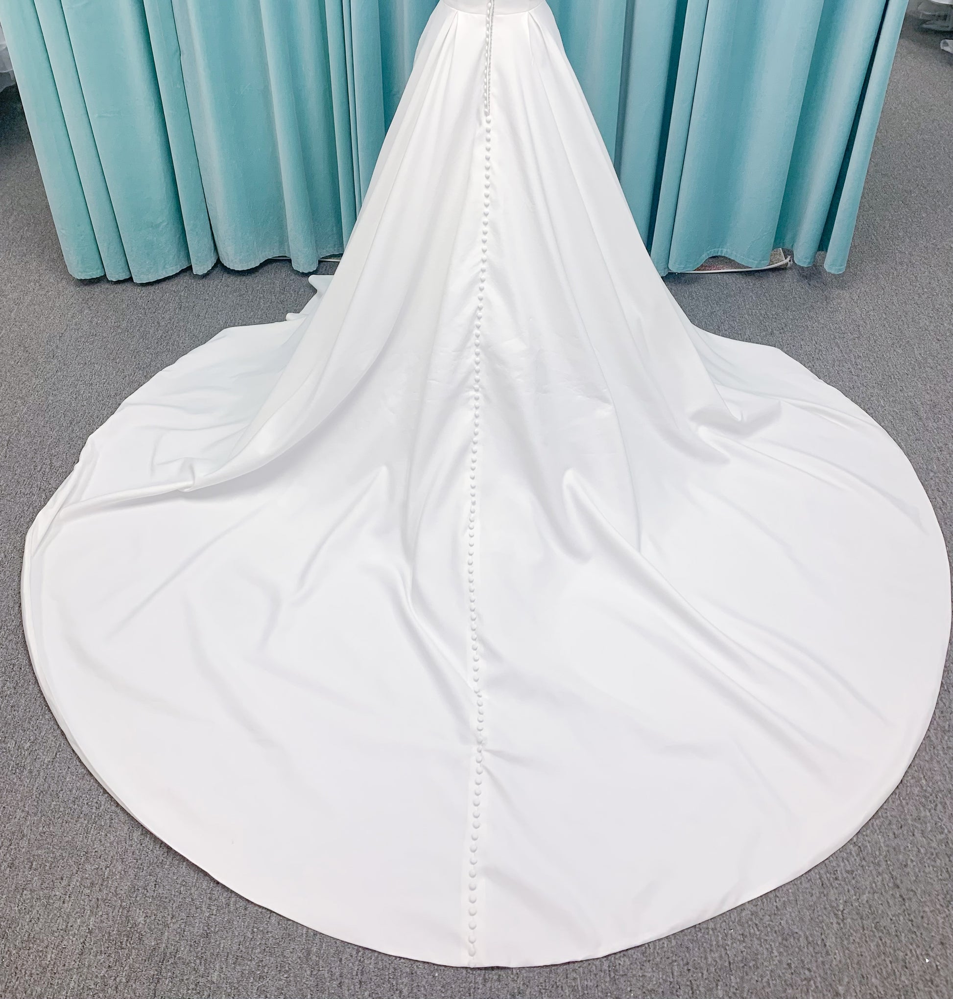 Morilee 4473 Reba A-line wedding dress in Larissa satin with cowl strapless neckline, detachable organza bow tie straps, and covered buttons to hem.