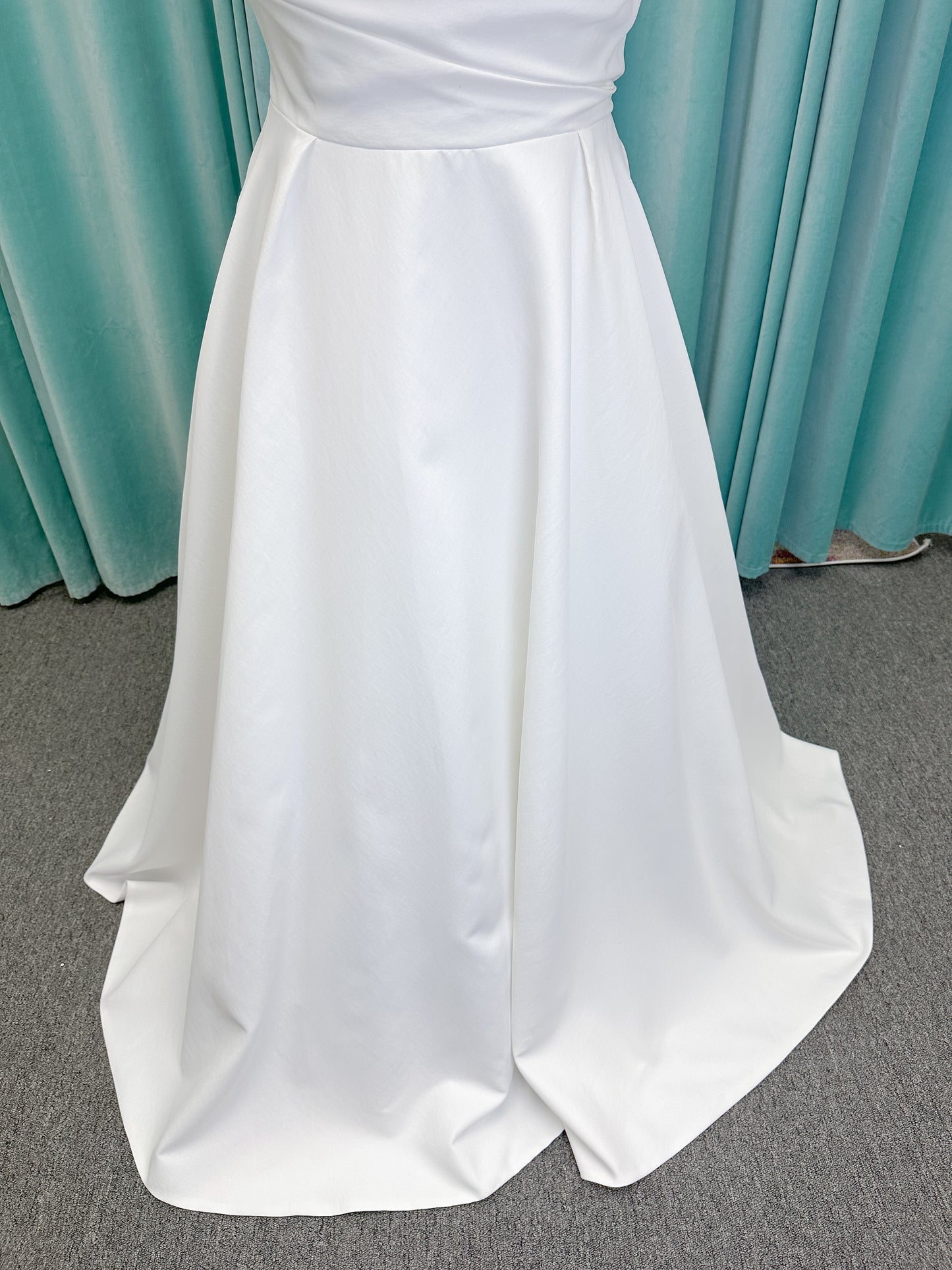 Morilee 4473 Reba plus size A-line wedding dress in Larissa satin with cowl strapless neck, detachable organza bow tie straps, and covered buttons to hem.