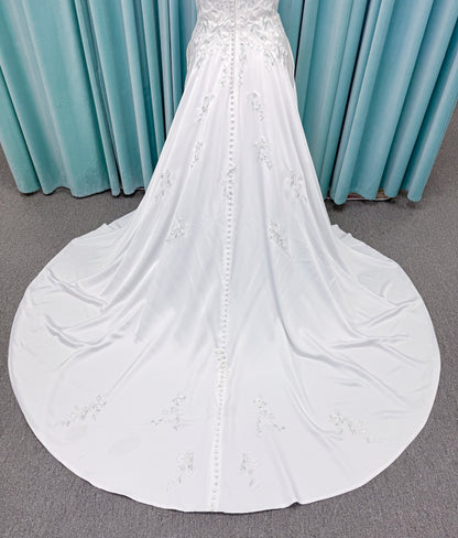 Morilee 4471 Roberta plus size wedding dress on mannequin with angular strapless neckline, 3D floral beaded embroidery, and satin A-line skirt