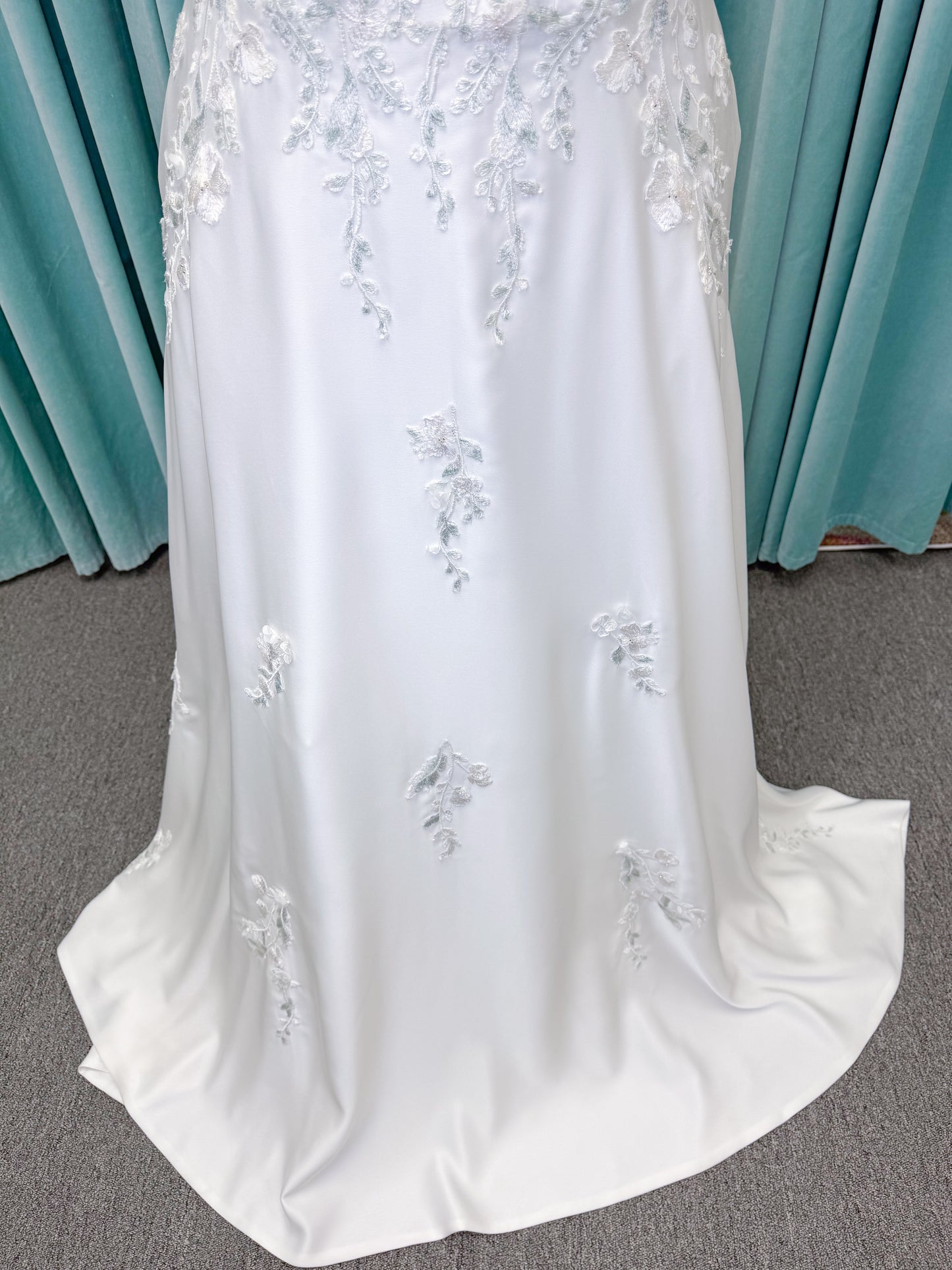 Morilee 4471 Roberta plus size wedding dress on mannequin with angular strapless neckline, 3D floral beaded embroidery, and satin A-line skirt