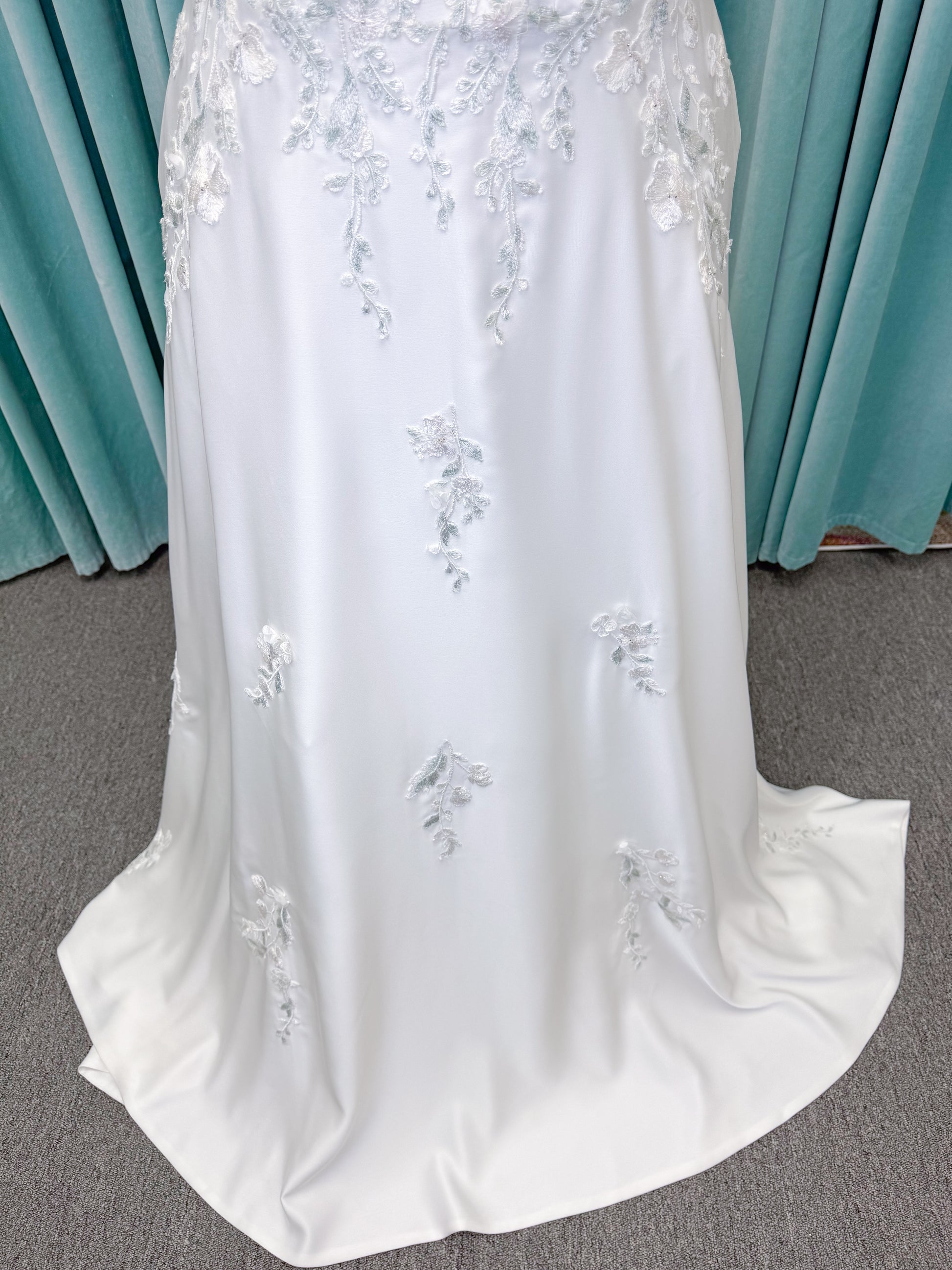Morilee 4471 Roberta plus size wedding dress on mannequin with angular strapless neckline, 3D floral beaded embroidery, and satin A-line skirt