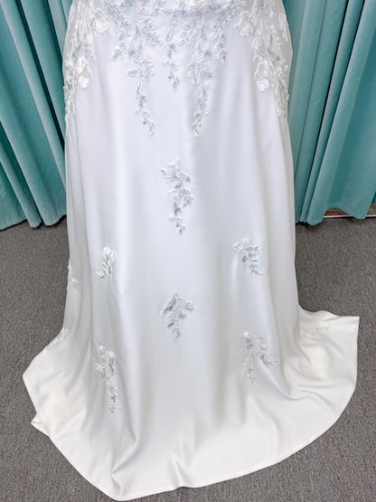 Morilee 4471 Roberta plus size wedding dress on mannequin with angular strapless neckline, 3D floral beaded embroidery, and satin A-line skirt