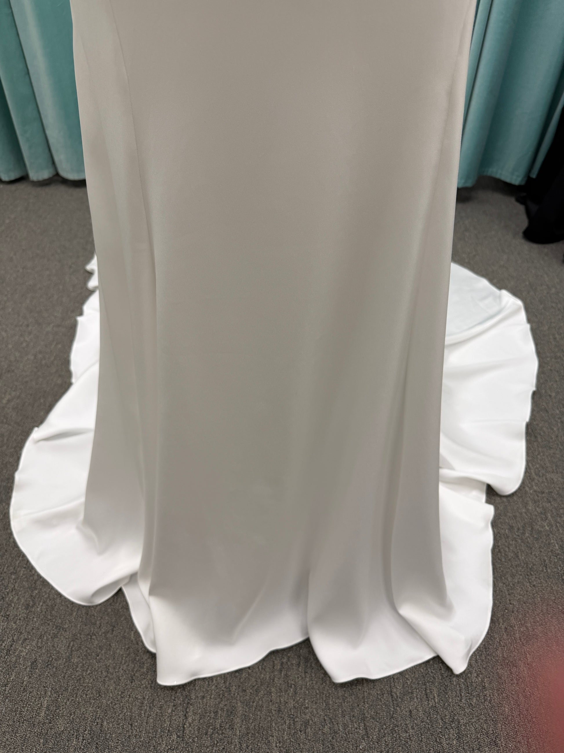 Stella York 8028 ivory lace fit-and-flare wedding dress on mannequin featuring high illusion neckline, sheer long lace sleeves, plunging bodice, and low open back.
