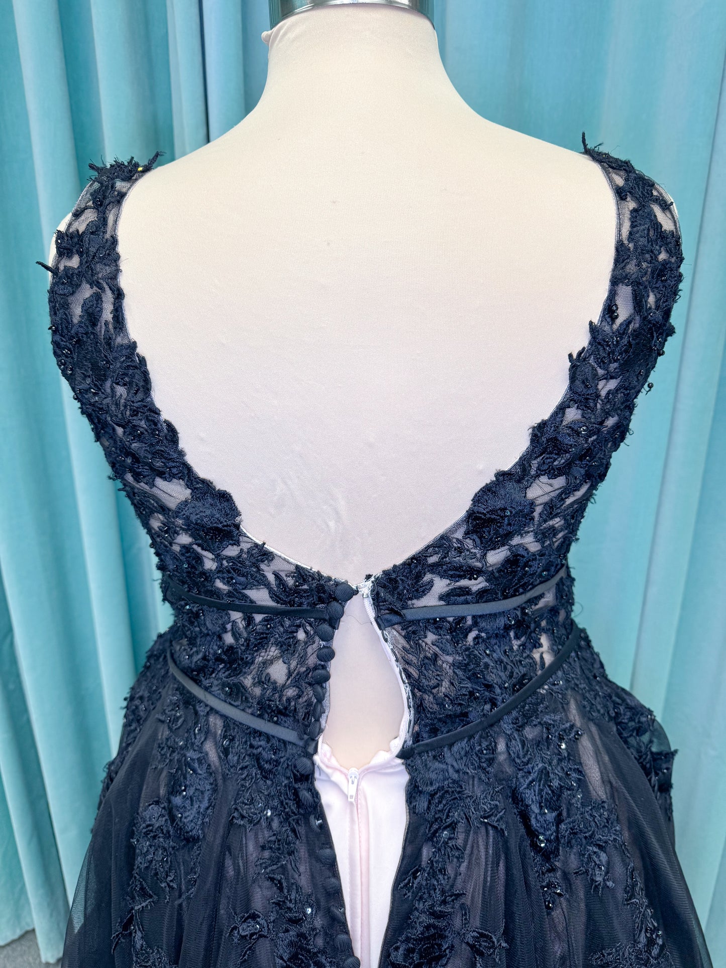 Morilee 5763 Rosa plus size A-line wedding dress on mannequin with plunging V-neckline, double banded waist, and crystal beaded floral lace appliques