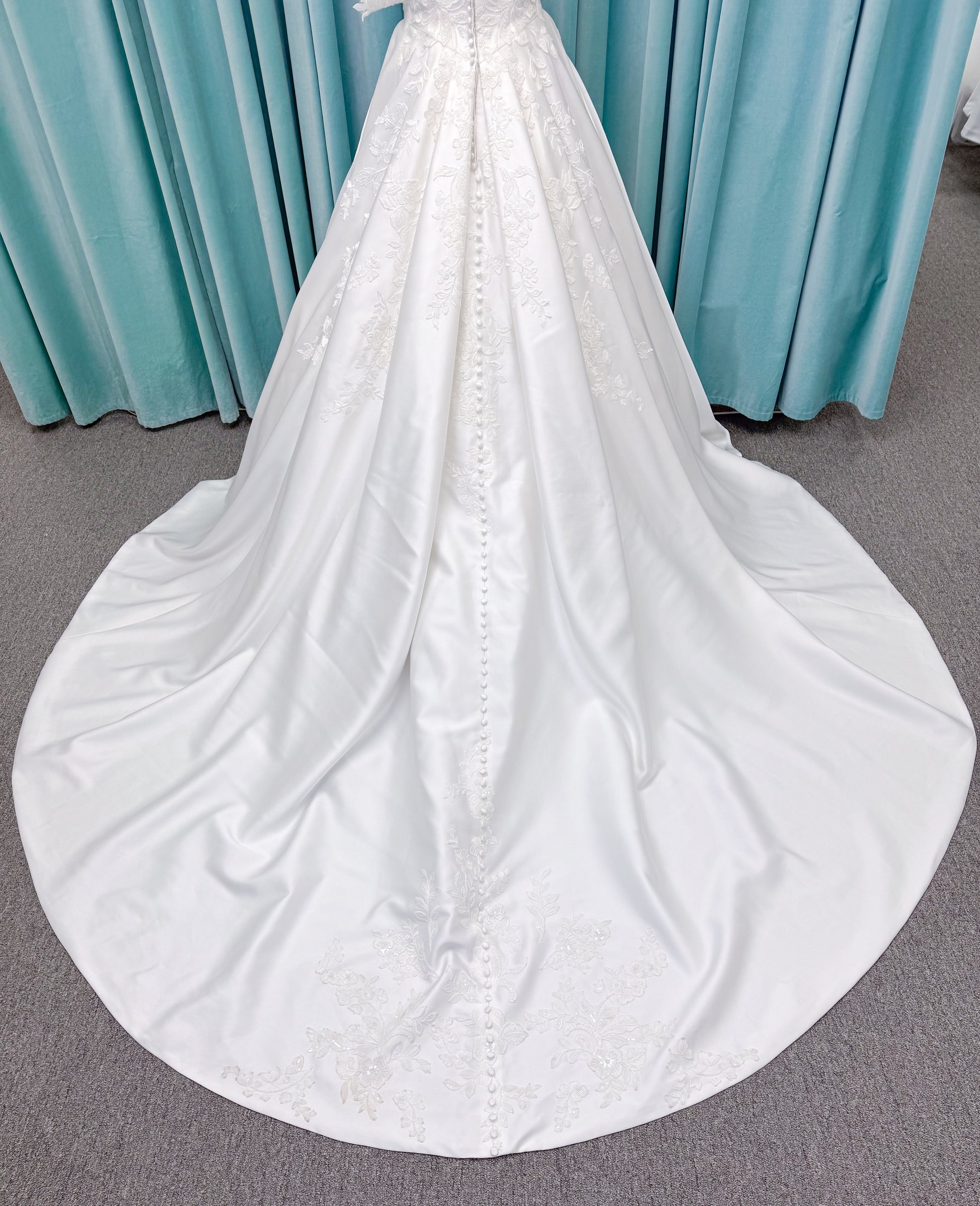 Morilee 2643 Rosemarie A-line wedding dress on mannequin with sweetheart plunging neckline, long sleeves, and frosted embroidered lace appliques