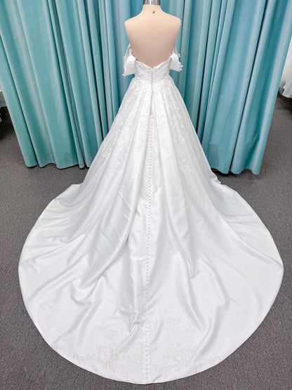 Morilee 2643 Rosemarie A-line wedding dress on mannequin with sweetheart plunging neckline, long sleeves, and frosted embroidered lace appliques